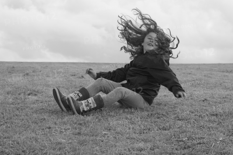 Young Girl Having Fun and Falling on Ground