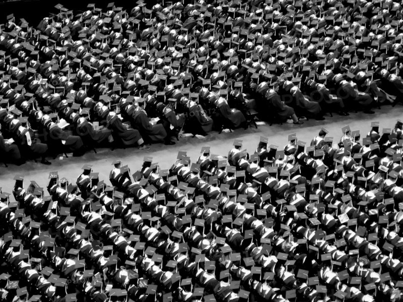 College Graduates Sitting at Graduation Ceremony