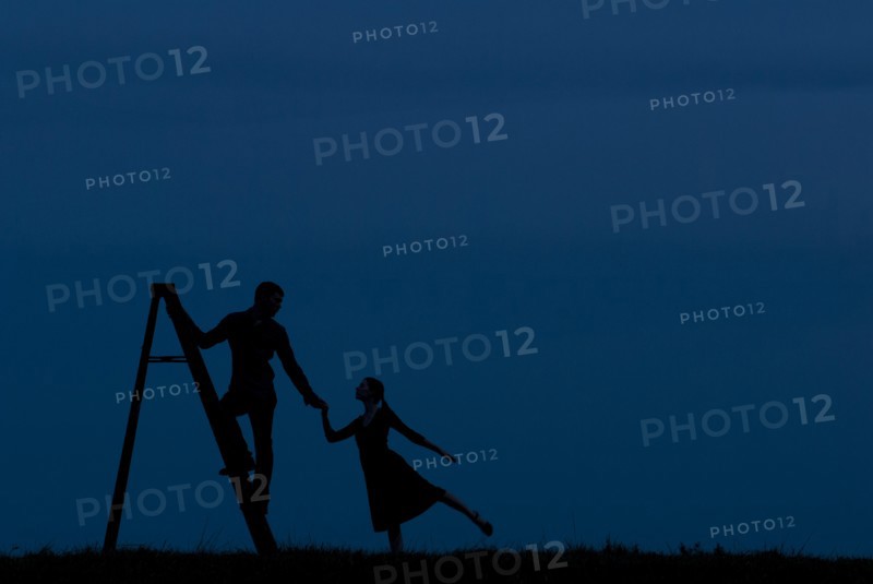 Man Standing on Ladder While Holding Woman's Hand, Silhouette