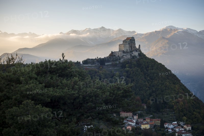 Sacra di San Michele at Sunset with Alps in Background and Village of San Pietro Below, Italy