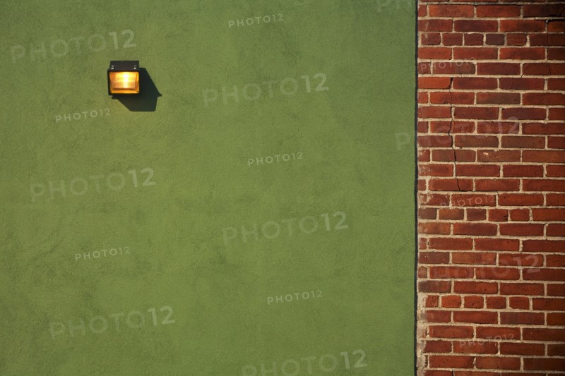 Light Fixture on Green Wall With Red Brick Wall Border