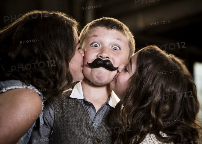 Two Girls Kissing Boy with Wax Lips in Abandoned Warehouse