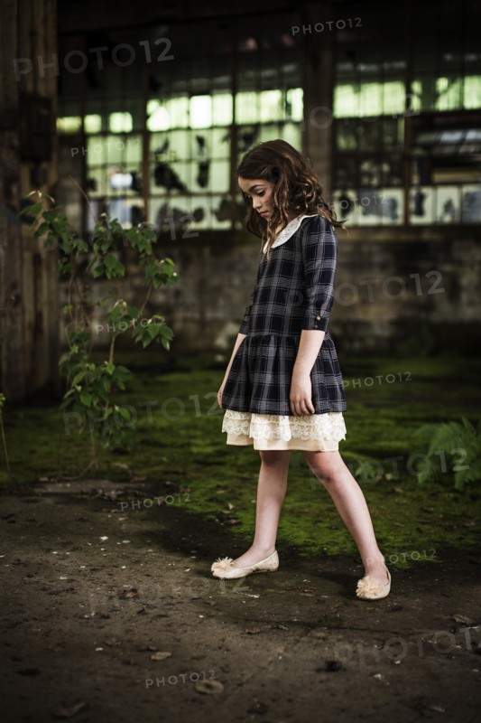 Young Girl Looking Down in Abandoned Warehouse, Portrait