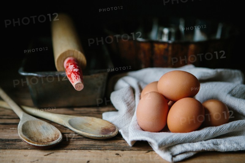 Brown Eggs with Wood Spoon, Baking Tins and Roller