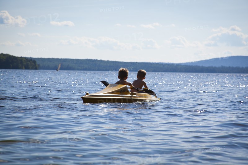 Two Young Boys Paddling Kayak, Rear View