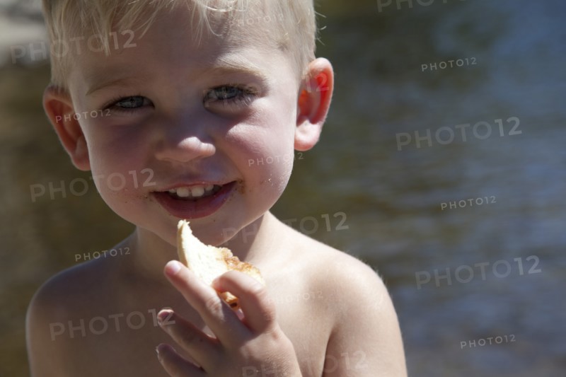 Smiling Boy Eating Bread