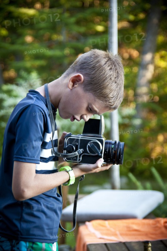 Profile of Young Boy with Camera