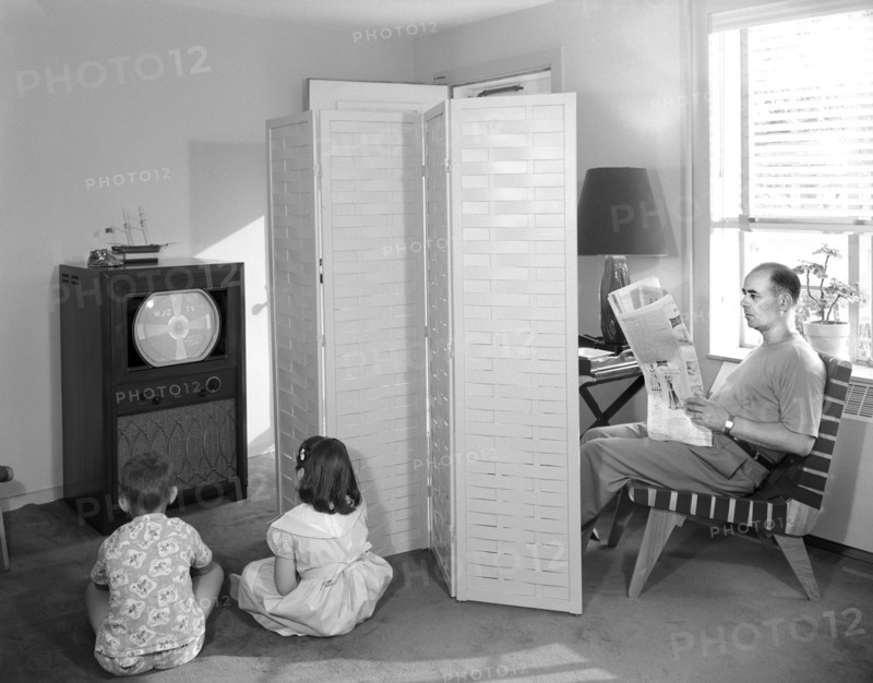 Father Reading Newspaper while Two Children Watch Television, Gottscho-Schleisner Collection, 1950