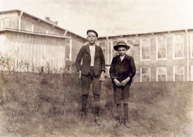 Arthur Shelly (left), 14 years old and Tommy Ashville, about 11 years old, Textile Mill Workers, Full-Length Portrait, Chester, South Carolina, USA, Photograph by Lewis Wickes Hine, November 1908
