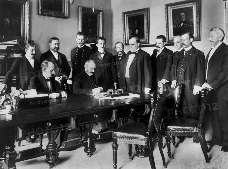 U.S. President William McKinley Looks on as Peace Protocol is Signed by French Ambassador Pierre Paul Cambon, Leading to the end of the Spanish-American War, Washington DC, USA, Francis Benjamin Johnston, August 12, 1898