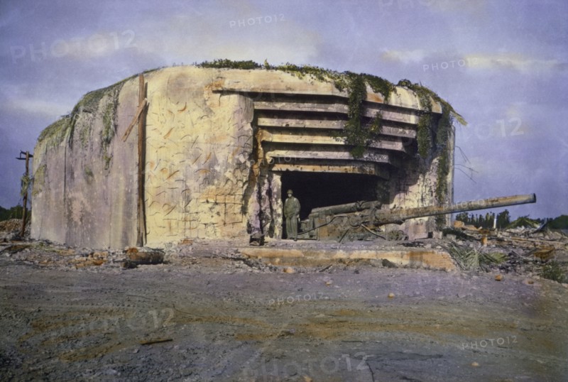 U.S. Soldier Standing at Knocked Out Crisbecq Battery near Utah Beach, Saint-Marcouf, Normandy, France, June 1944
