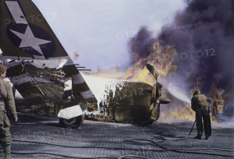 U.S. Soldier trying to Extinguish Flames of Burning Republic P-47 Fighter Plane on Ground during Invasion of Normandy, Cotentin Peninsula, France, June 1944
