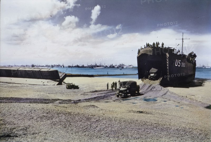 Trucks Exit From The Hold Of A US Naval LST on Beach After Storm Wrecked Artificial Mulberry Harbors, Normandy, France, June 1944
