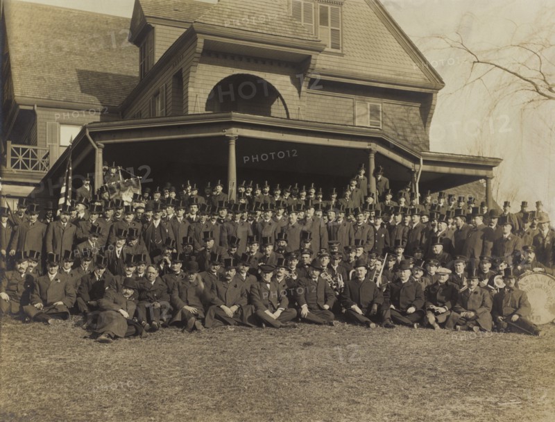 Ex-President Theodore Roosevelt (1st row, center). Sitting on Lawn of his Residence, Sagamore Hill, with a group of Men in Top Hats, Oyster Bay, New York, USA, March 31, 1909