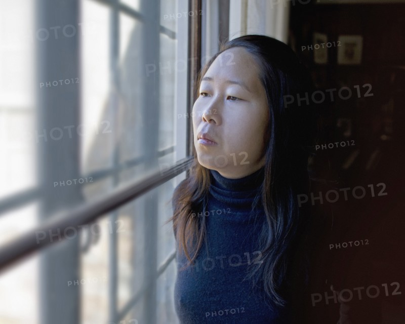 Portrait of Contemplative Woman Looking out Window
