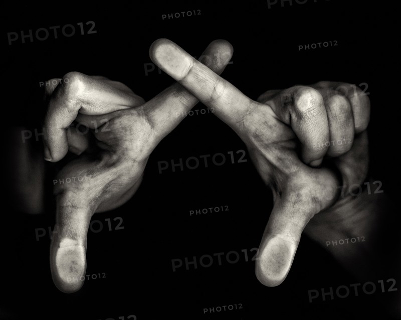 Two Hands with Crossing Forefingers on Black Background