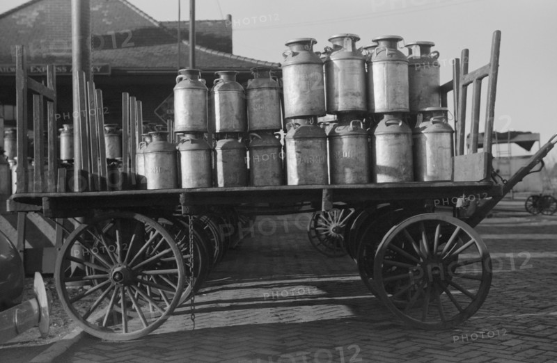Milk cans at Railroad station. Minot