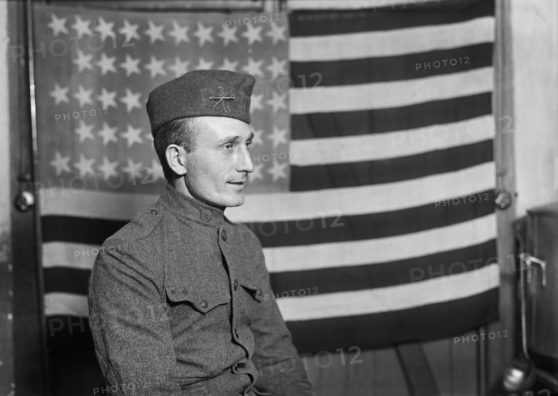 Half-Length Portrait of American Soldier with American Flag in Background