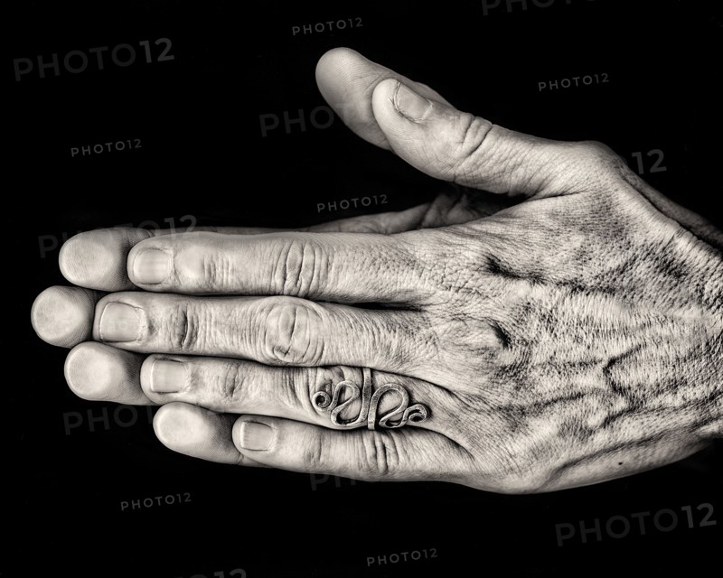Two Hands Pressed Together against Black Background