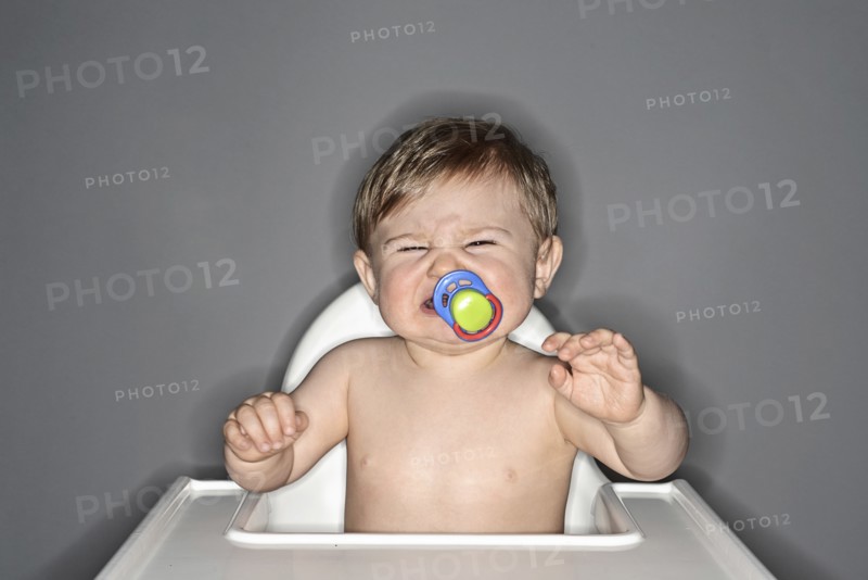 Crying Baby Boy with Pacifier in his Mouth