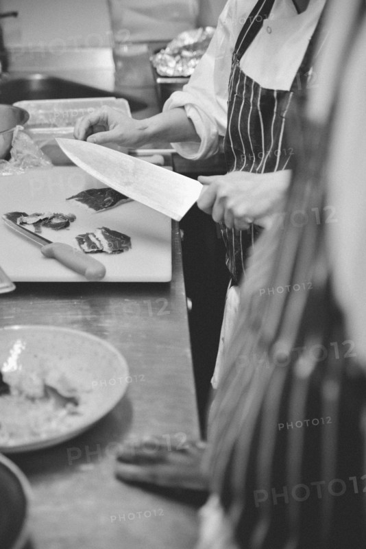 Chef Slicing Meat with Knife