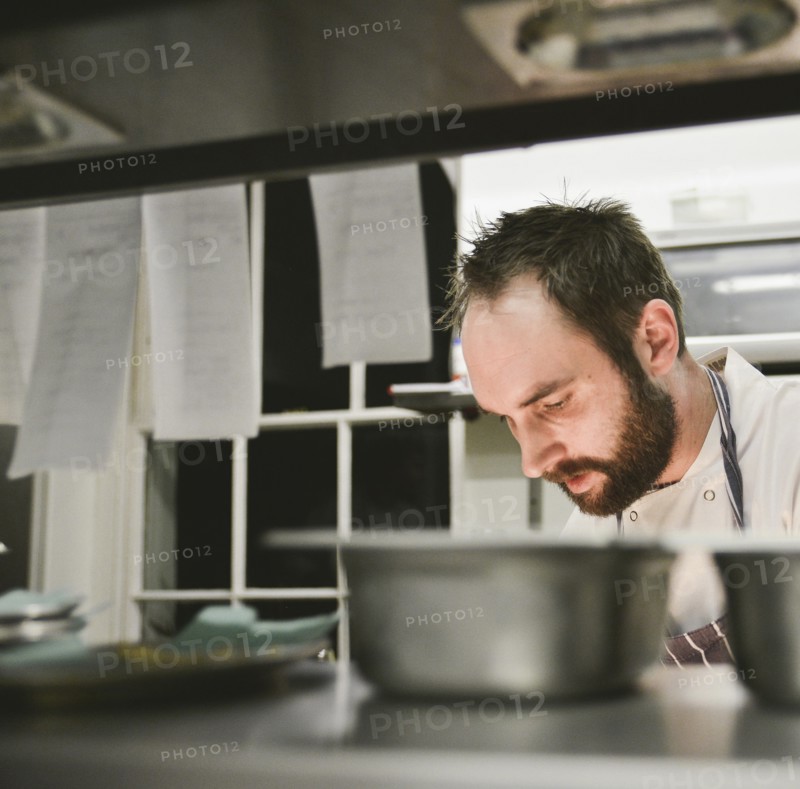 Head and Shoulders view of Chef in Restaurant Kitchen
