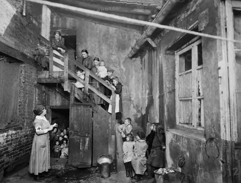 American Red Cross Nurse visiting Refugees in Housing Condemned before the War