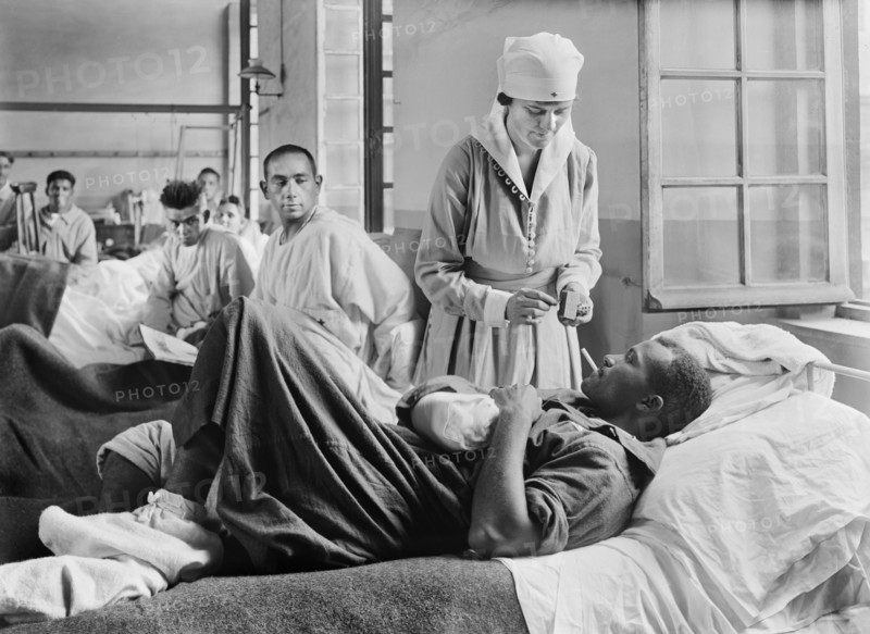 Injured American Soldier receiving Cigarette from American Red Cross Worker at Base Hospital 41