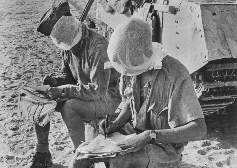 Two British Soldiers with their heads covered by Mosquito Nets