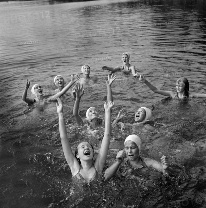 Group of Girls waiting to Catch Large Rubber Ball in Lake