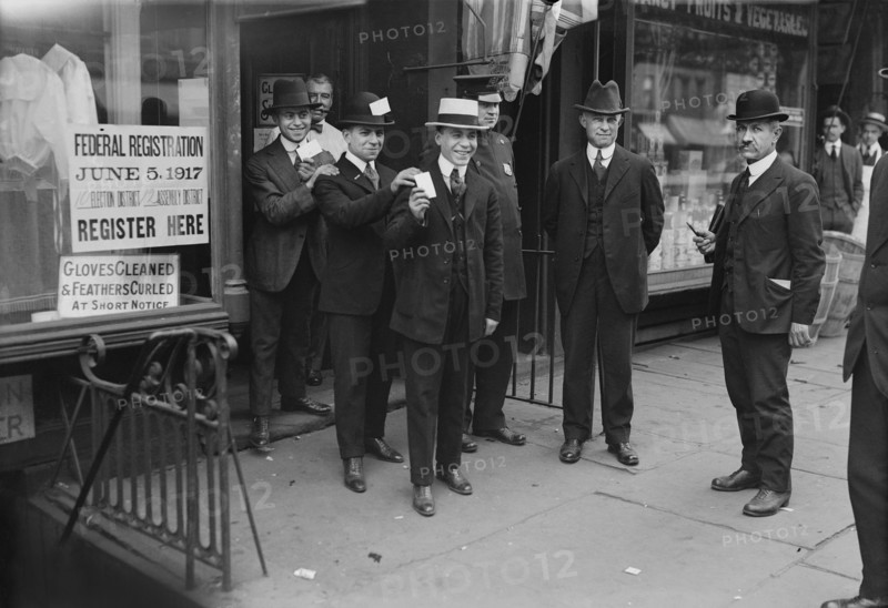 Men holding Draft Cards coming out of Building after registering for the Draft during World War I