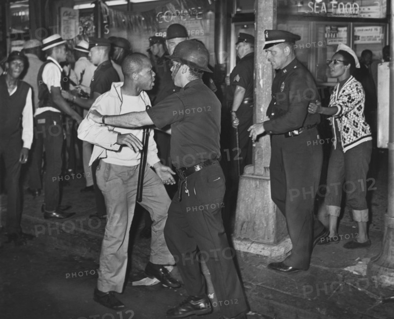 Policemen confront group of People after night of rioting due to fatal shooting of Teen James Powell by Police Officer Lt. Thomas Gilligan, Fulton St. and Nostrand Ave.,