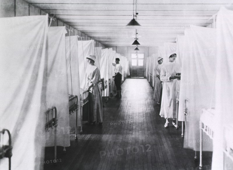 Nurses and Orderlies standing at foot of Beds separated by Sheets, Influenza Ward, 1918