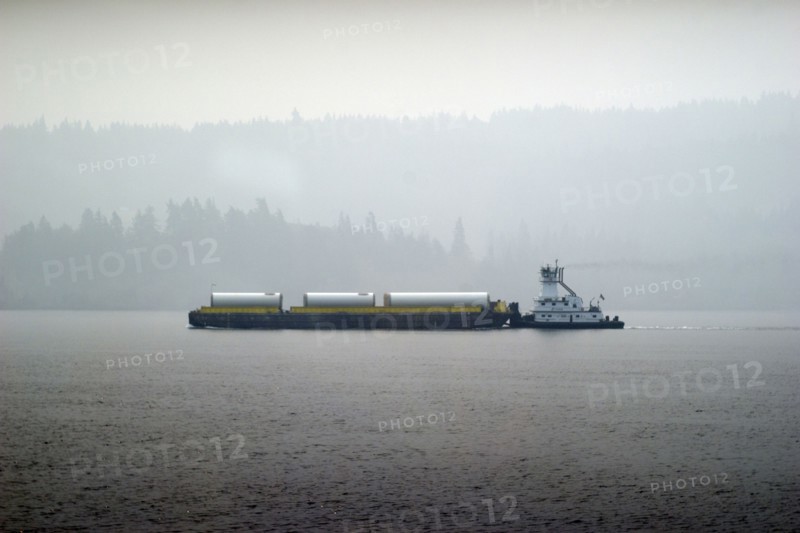 Barge in Columbia river, wildfire smoke obstructing distant view,