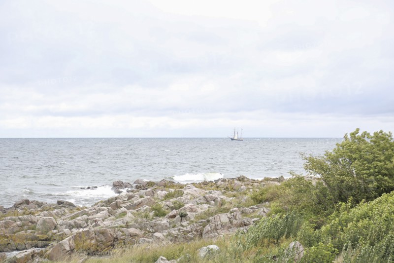 Wooden Sailboat off Rocky Beach, Bornholm,