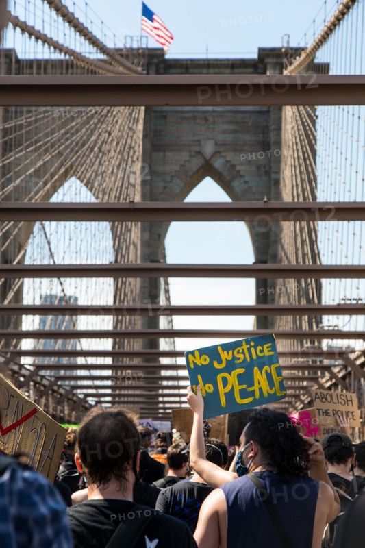 Crowd of Protesters with Signs, "No Justice No Peace",