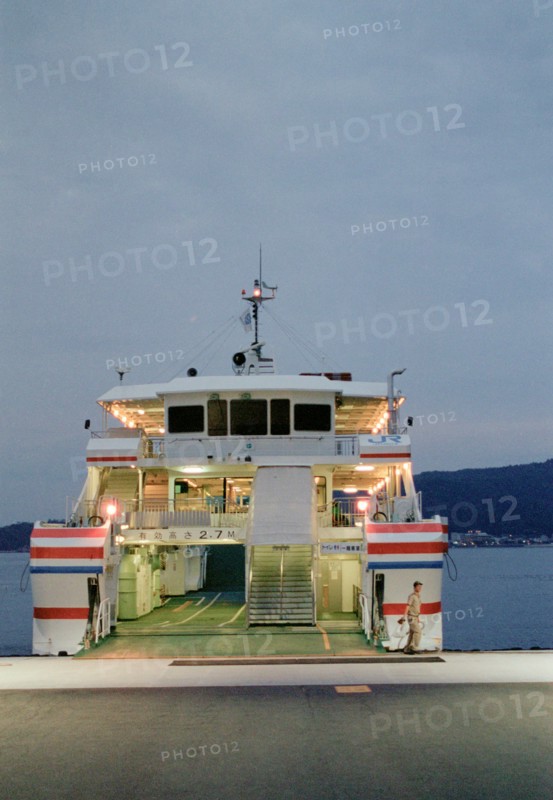 Ferry Worker in front of Boat at Sunset, Miyajima,
