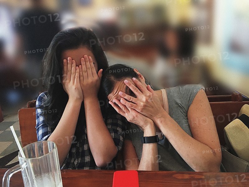 Mother and Daughter hiding their Faces,,