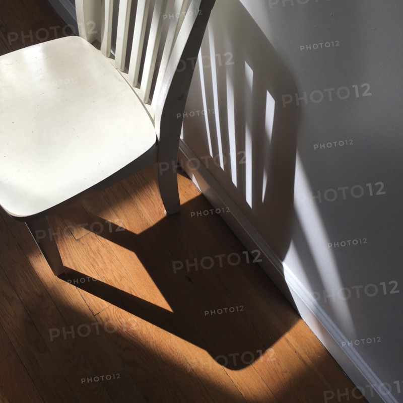 High Angle View of Child's Chair against Wall with Shadows,,