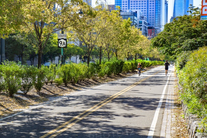 Cyclist and Jogger on Bike and Jogging Path along West Side Highway, New York City,