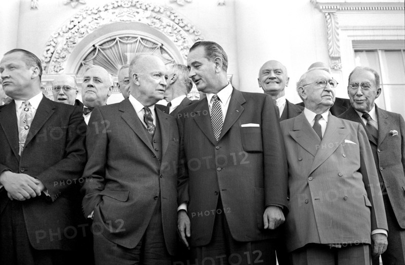 U.S. President Dwight D. Eisenhower standing with U.S. Senator from Texas Lyndon B. Johnson (center), U.S. Secretary of State John Foster Dulles (right) and other guests
