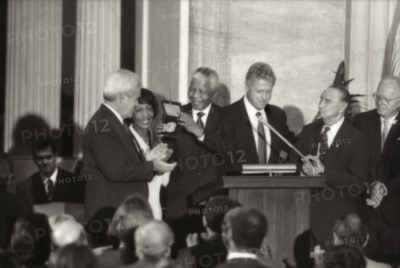 Nelson Mandela receiving Congressional Gold Medal from U.S. President Clinton