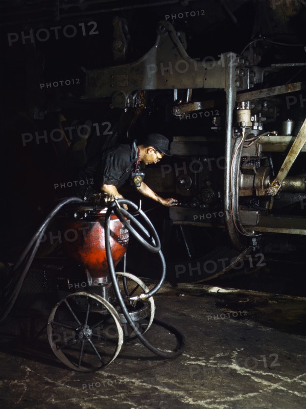 Thomas Madrigal greasing Locomotive Train in Roundhouse