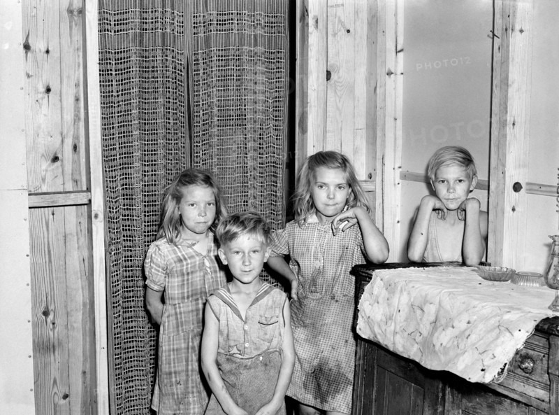 Children of Family that moved into Prefabricated House built by U.S. Farm Security Administration (FSA) to house some of Farmers who had to move out of the area being taken over by the Army