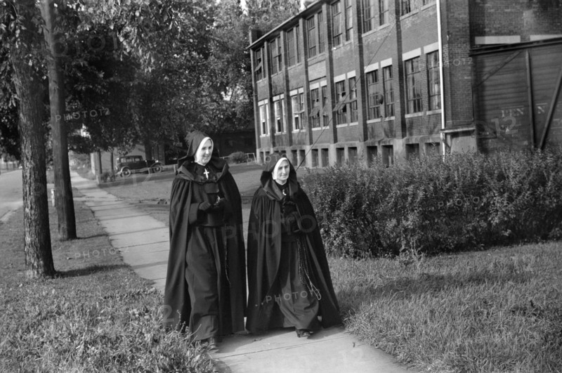 Two Nuns walking along Street