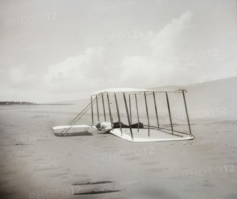 Wilbur Wright in prone position on glider just after landing