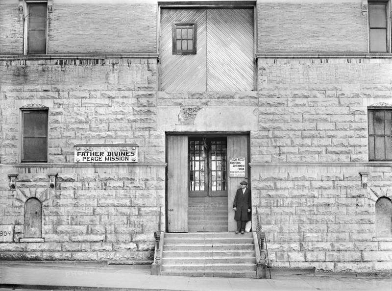 Man standing on steps of Father Divine's Peace Mission