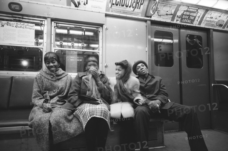 Four young adults sharing Laugh on Subway