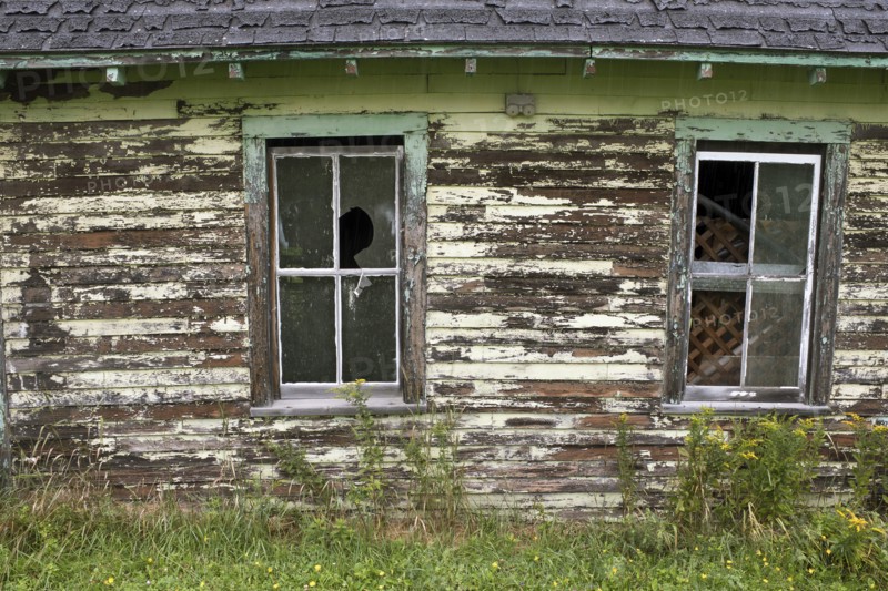 Old Barn with Two Broken Windows and Peeling Paint
