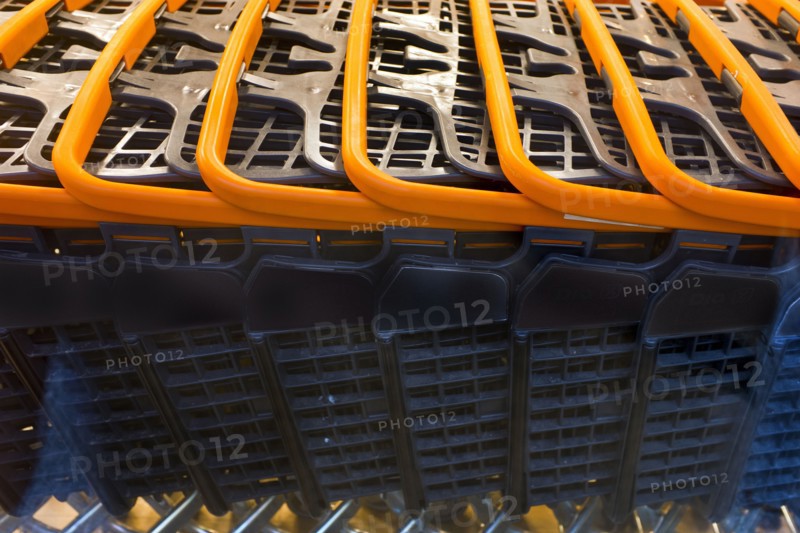 Detail of Row of Shopping Carts with Orange Handles
